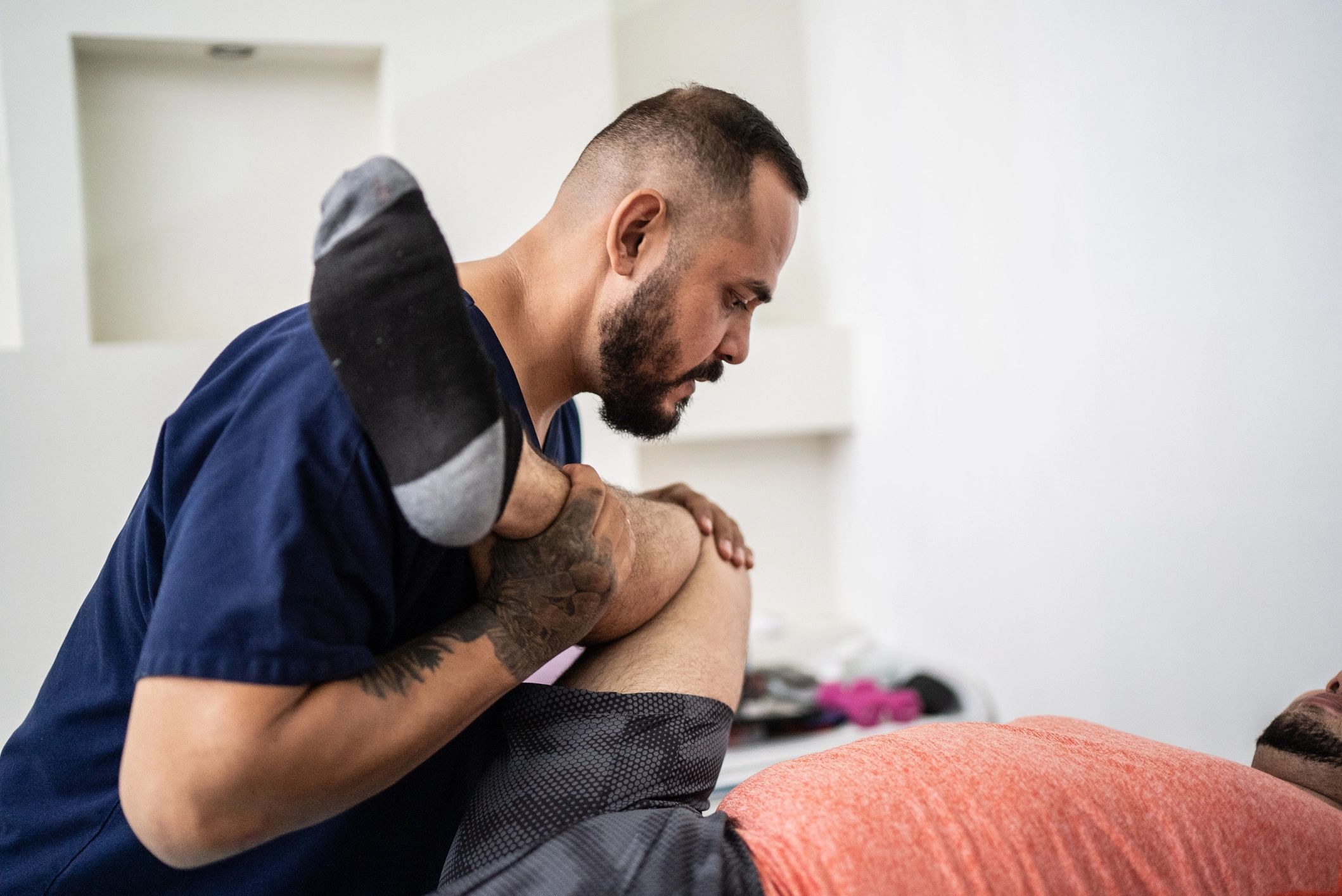 Therapist providing hands-on therapy in a clinic setting