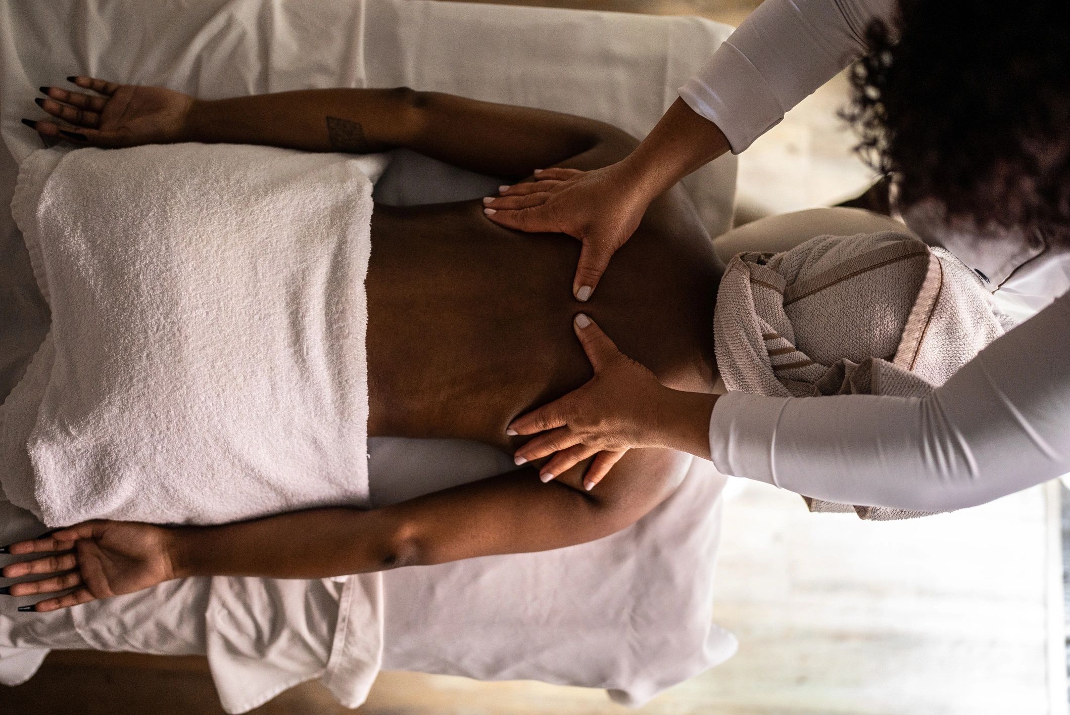 Massage therapist working with a client during a treatment session