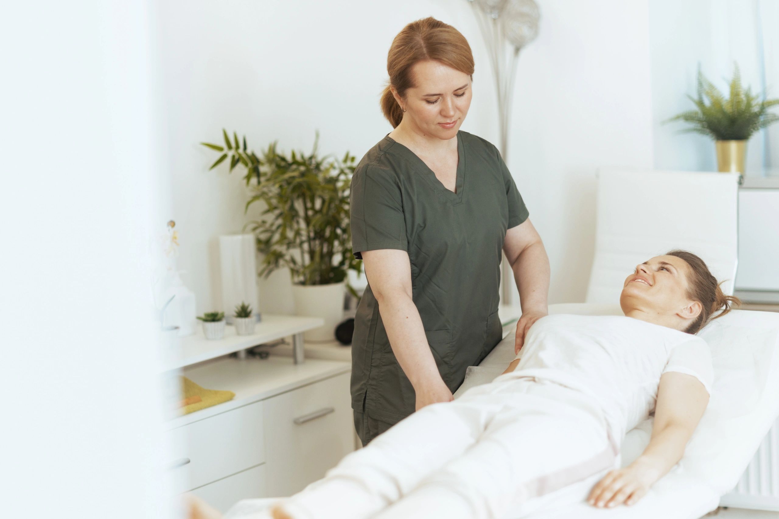 Smiling massage therapist in a treatment room